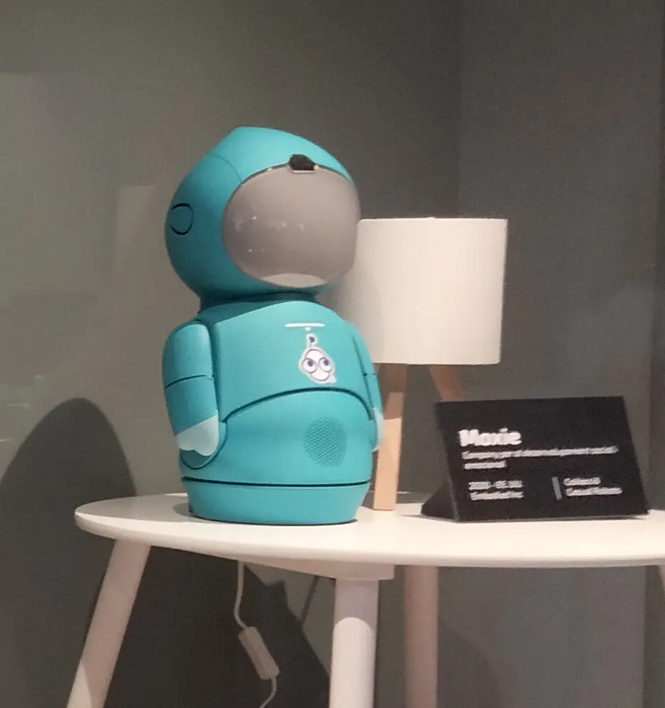 A teal Moxie on a table in an exhibition