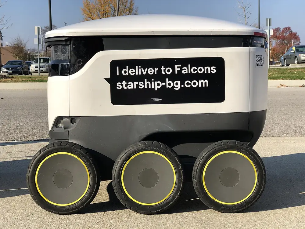 Side view of a six-wheeled Starship delivery robot